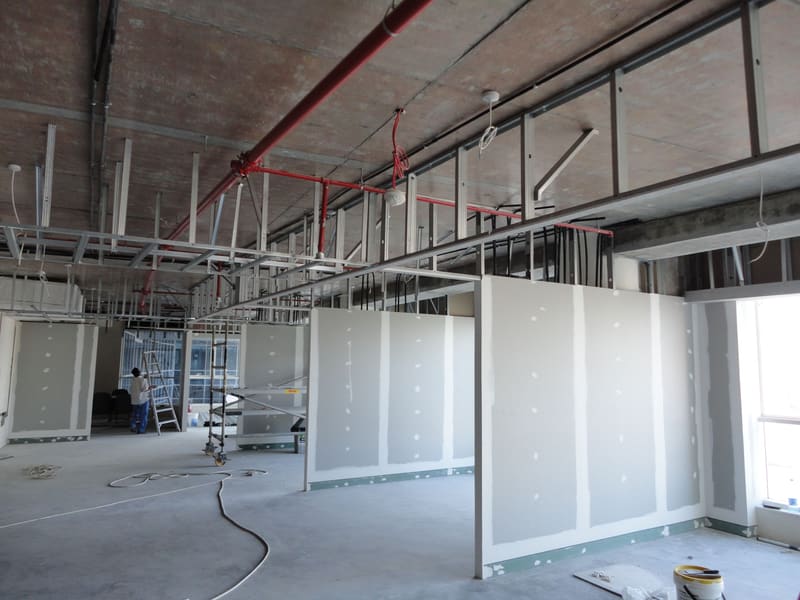 Open-plan floor during refurbishment, with new framing and services in the ceiling